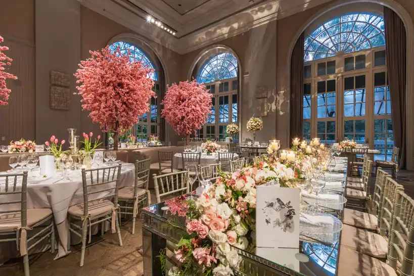 Modern wedding reception setup with soft pink lighting